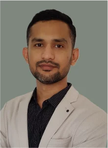 Wasim, a man in a light jacket and dark shirt, looking at the camera